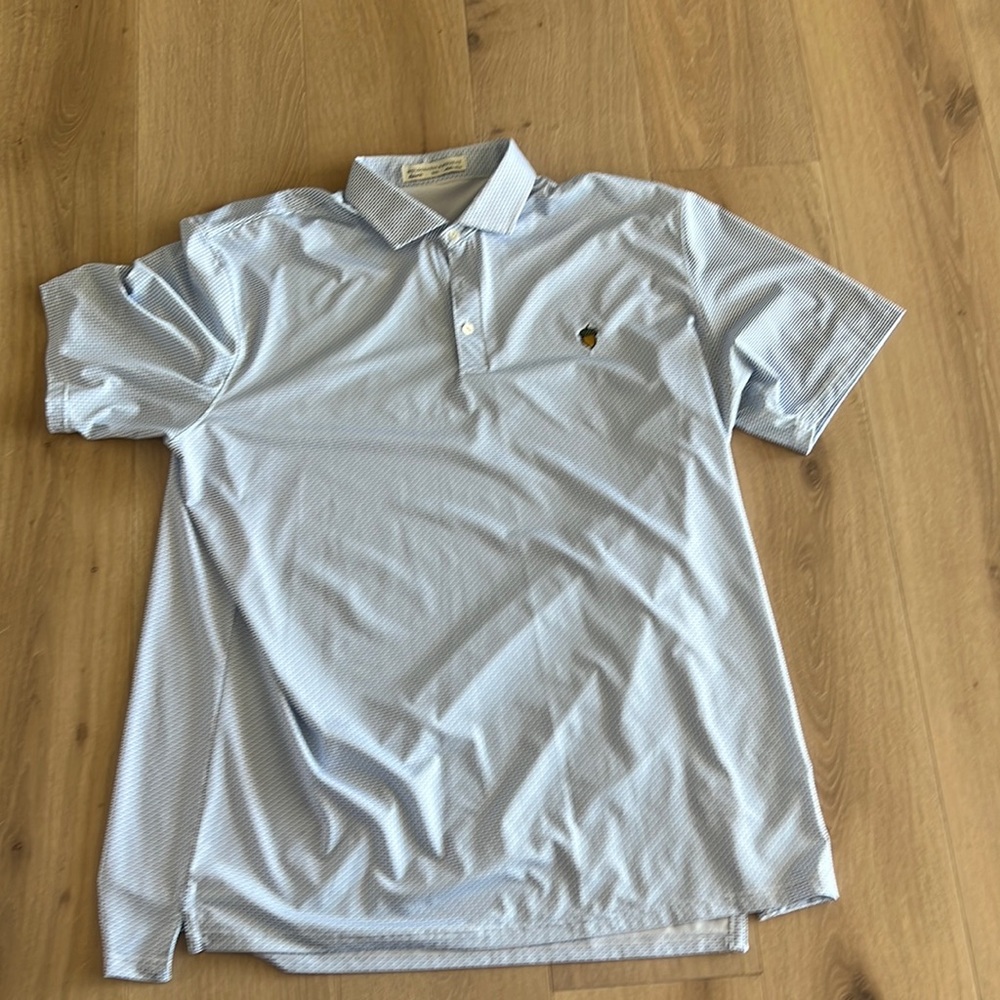 This is a blue Holderness and Bourne Golf shirt.